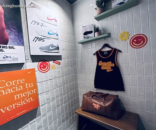 A small retro-themed display with a focus on athletic apparel and shoes. The walls feature a series of posters showcasing various Nike shoes from different years. A black gym tank top and a brown leather gym bag are prominently positioned on a wooden bench. There are decorative elements like potted plants on wall-mounted shelves and smiley face icons. The environment has a nostalgic and sporty atmosphere.